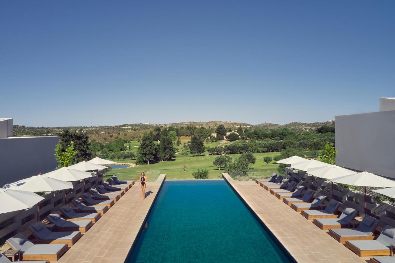 Minthis Resort Tsadha Bagian luar foto The pool at the hotel